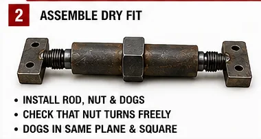 Shop-built push-pull tool dry-fitted with threaded rod, center nut, cylindrical body, and square dog plates.