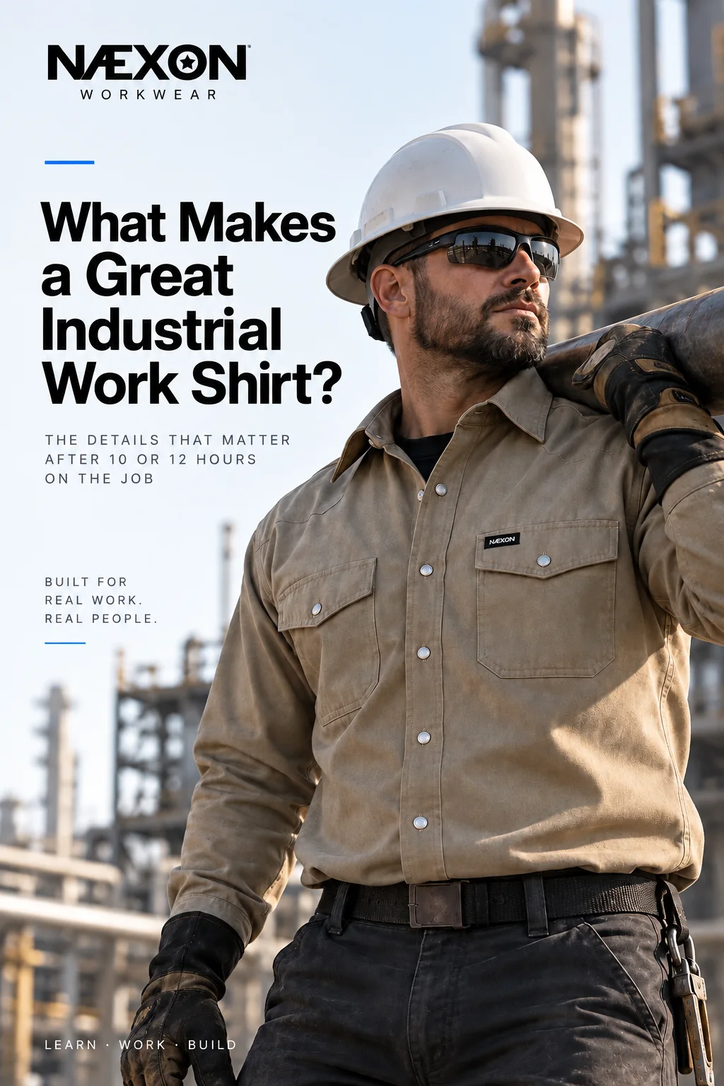 Industrial worker in hard hat and safety glasses wearing a tan long-sleeve work shirt and carrying material at a refinery.